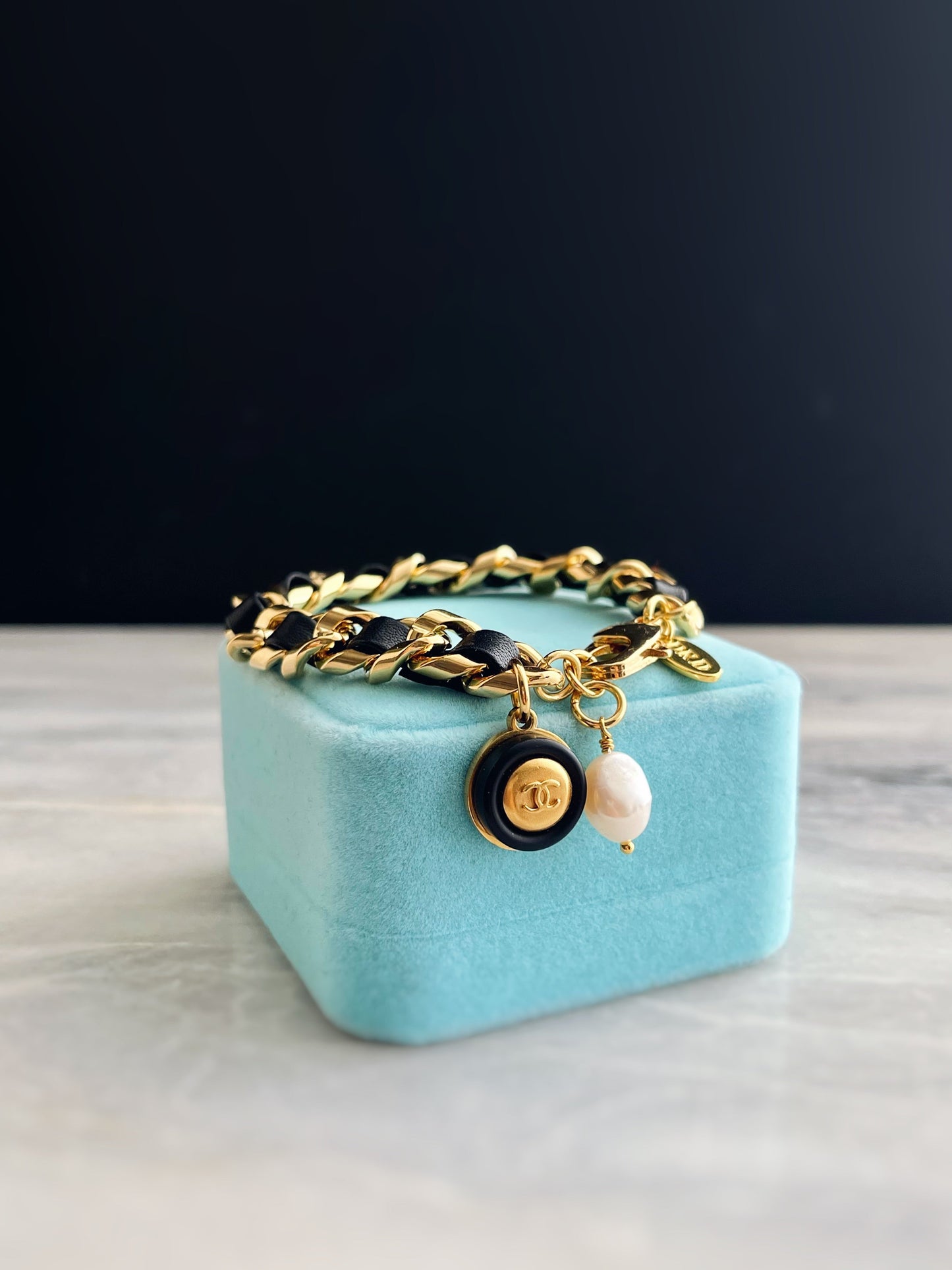 Small Authentic gold Reworked CHANEL button and black leather bracelet